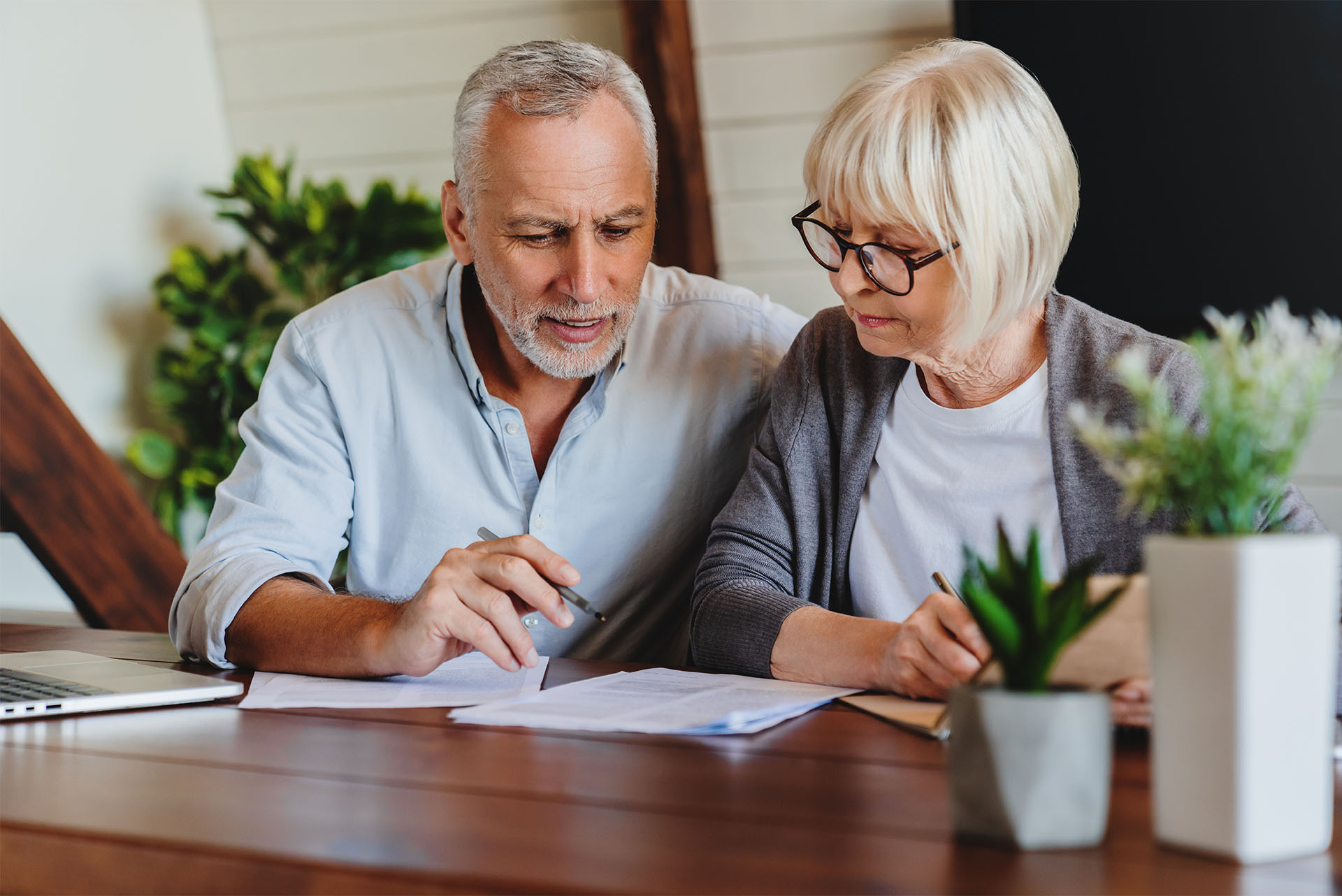 mature couple reviewing refinance options for their home